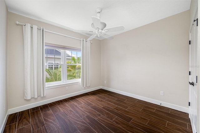 unfurnished room featuring dark wood-type flooring and ceiling fan