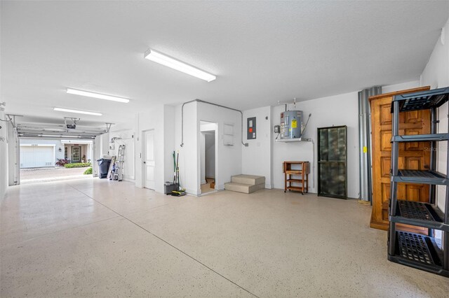 garage with electric panel and water heater