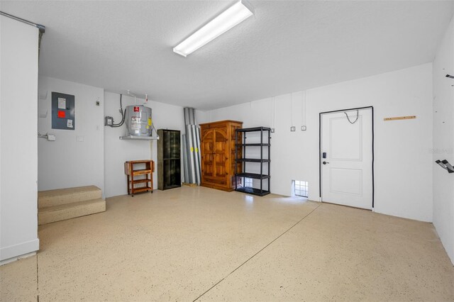 garage featuring water heater and electric panel