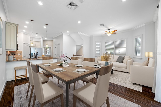 dining area with ceiling fan, dark hardwood / wood-style flooring, and ornamental molding