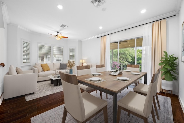 dining room with dark hardwood / wood-style flooring, ceiling fan, and crown molding