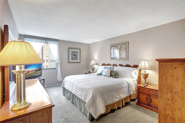 bedroom featuring a textured ceiling and light carpet