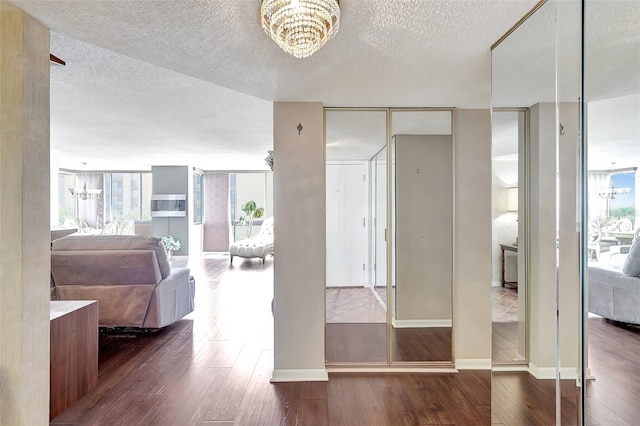 bedroom featuring a textured ceiling, hardwood / wood-style floors, and multiple windows