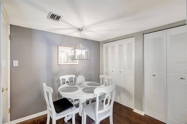 dining space featuring a chandelier and dark hardwood / wood-style flooring