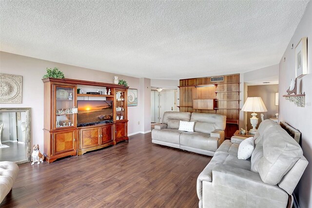 living room featuring a textured ceiling and dark hardwood / wood-style floors