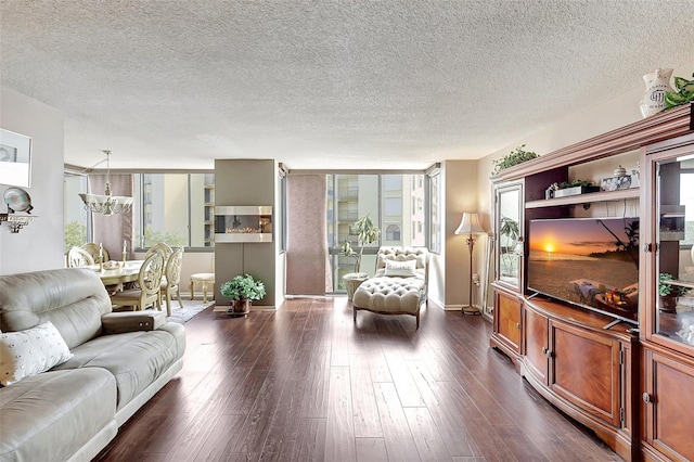 living room with a textured ceiling and dark wood-type flooring