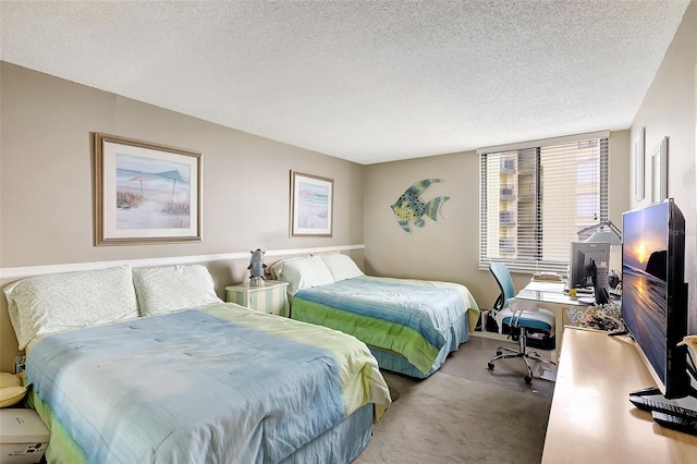 bedroom featuring carpet floors and a textured ceiling