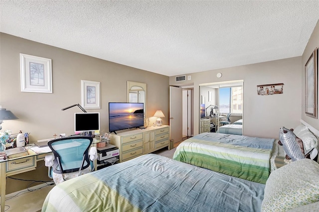 carpeted bedroom featuring a textured ceiling