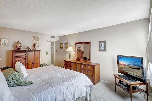 bedroom featuring a textured ceiling and light carpet