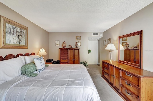 carpeted bedroom with a textured ceiling