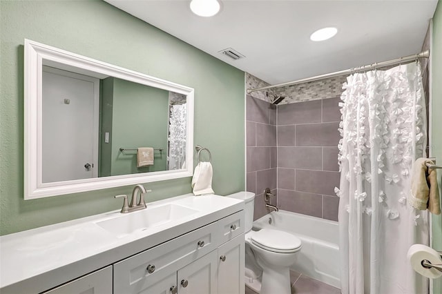 full bathroom with tile patterned flooring, shower / bath combo, vanity, and toilet