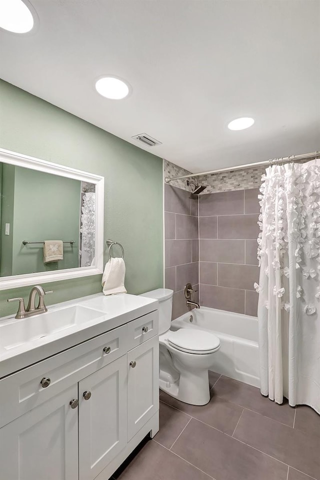 full bathroom with tile patterned floors, shower / bath combo, vanity, and toilet