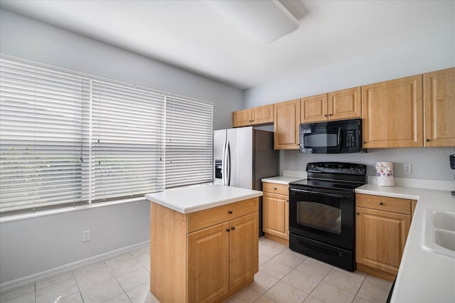 kitchen with black appliances, a kitchen island, and light tile patterned floors