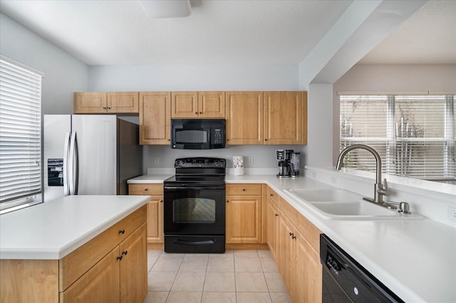 kitchen with black appliances, light tile patterned floors, sink, and light brown cabinets