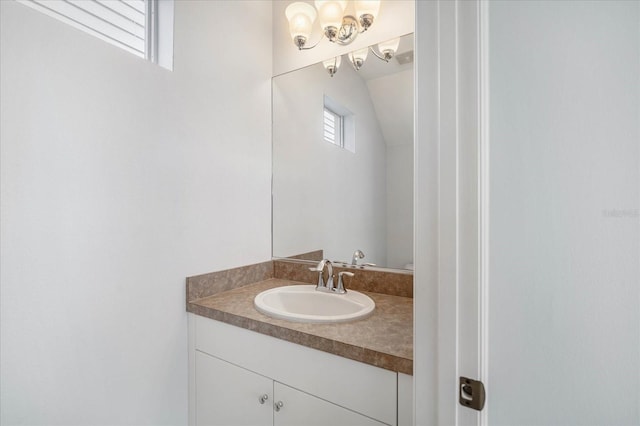 bathroom featuring vaulted ceiling and vanity