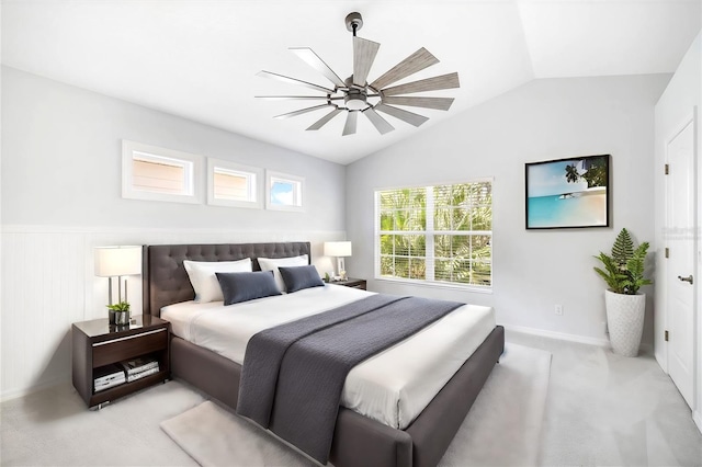 carpeted bedroom with lofted ceiling, multiple windows, ceiling fan, and wood walls