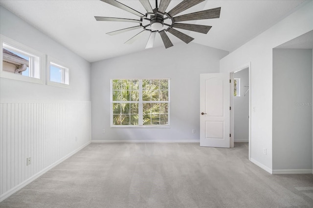 carpeted spare room with lofted ceiling and ceiling fan