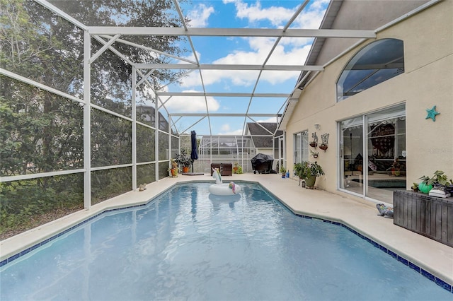 view of swimming pool featuring a lanai and a patio