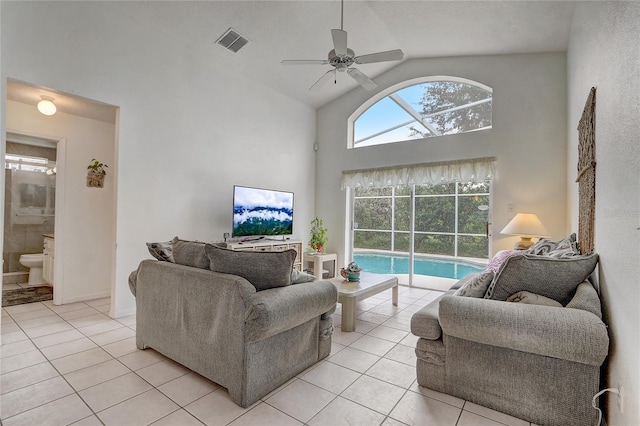 tiled living room with high vaulted ceiling and ceiling fan