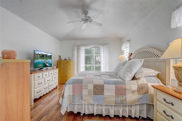 bedroom with ceiling fan, a textured ceiling, and light hardwood / wood-style flooring