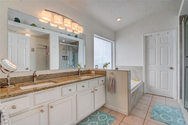 bathroom featuring tile patterned flooring, separate shower and tub, a textured ceiling, vaulted ceiling, and vanity