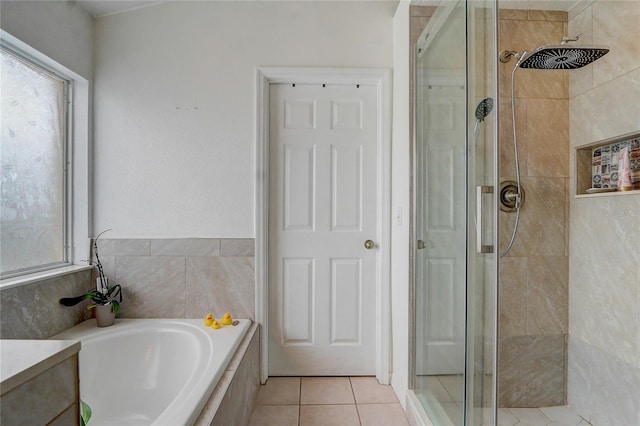 bathroom with tile patterned flooring and independent shower and bath