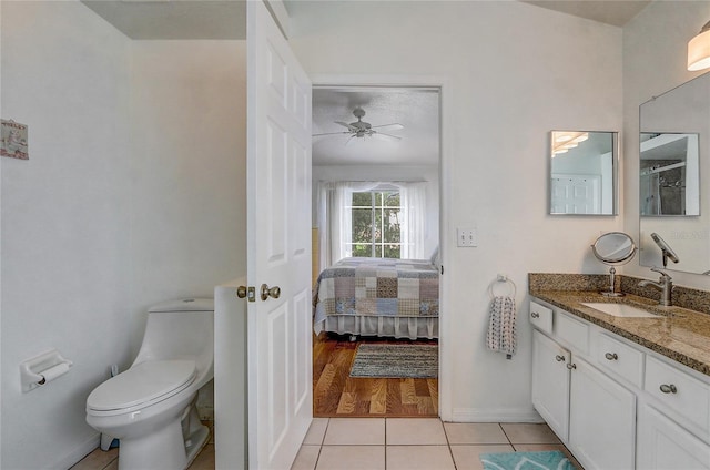 bathroom featuring hardwood / wood-style floors, ceiling fan, toilet, and vanity