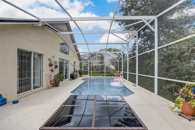 view of pool with a lanai and a patio