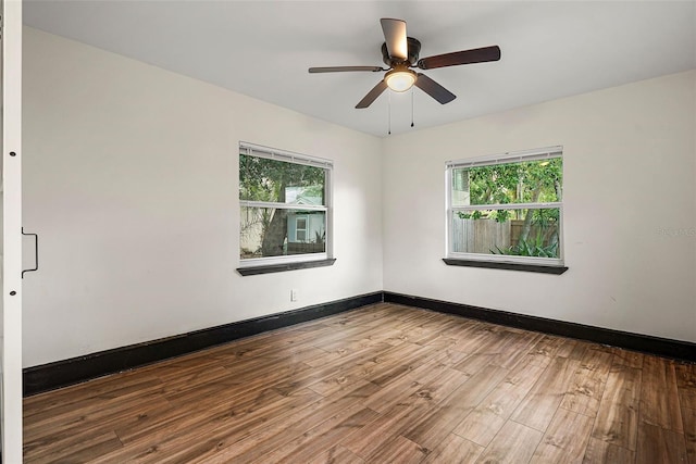 2111 Burlington Ave N, Saint Petersburg, FL 33713 - empty room with baseboards, ceiling fan, wood finished floors, and a healthy amount of sunlight