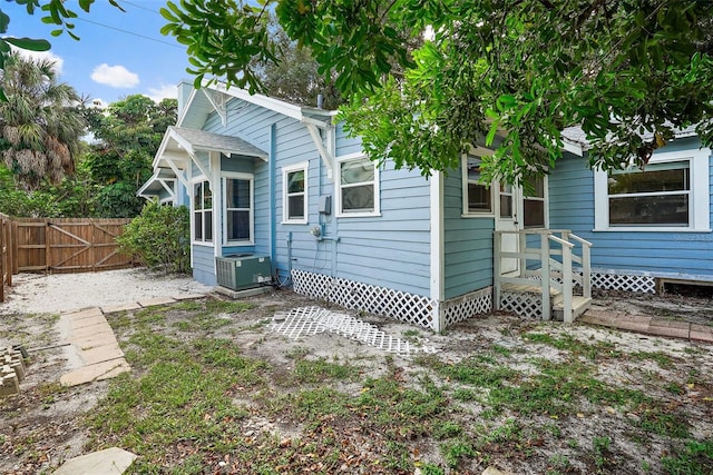 rear view of property with central AC unit