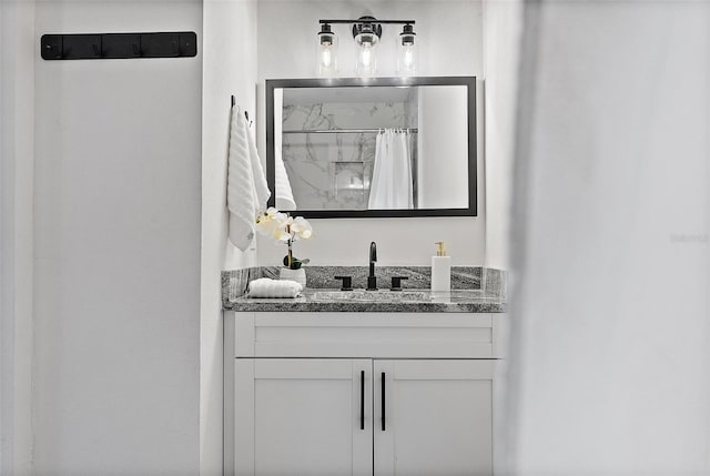 bathroom featuring vanity and a shower with shower curtain