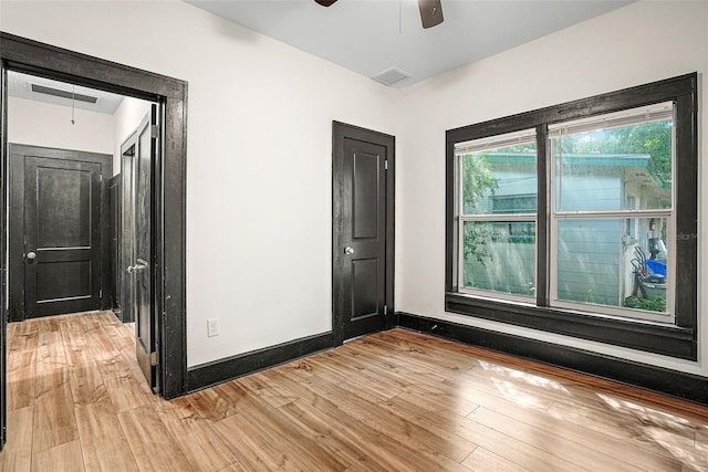 spare room with light hardwood / wood-style flooring and ceiling fan