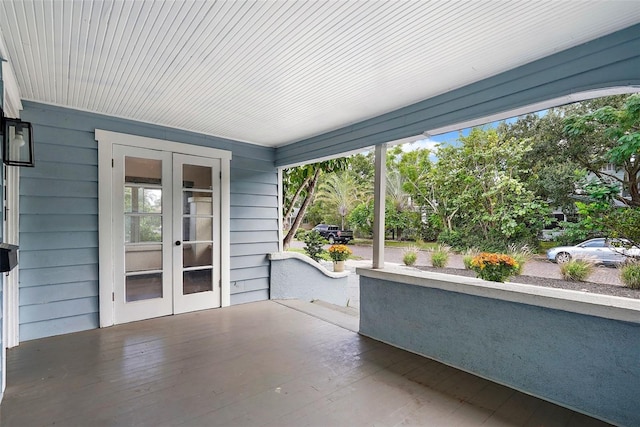 unfurnished sunroom with french doors