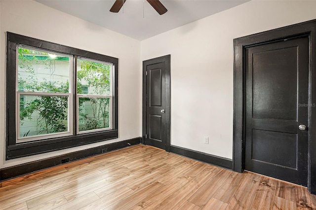 empty room featuring light wood-type flooring and ceiling fan