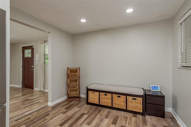 interior space with wood finished floors, baseboards, and recessed lighting