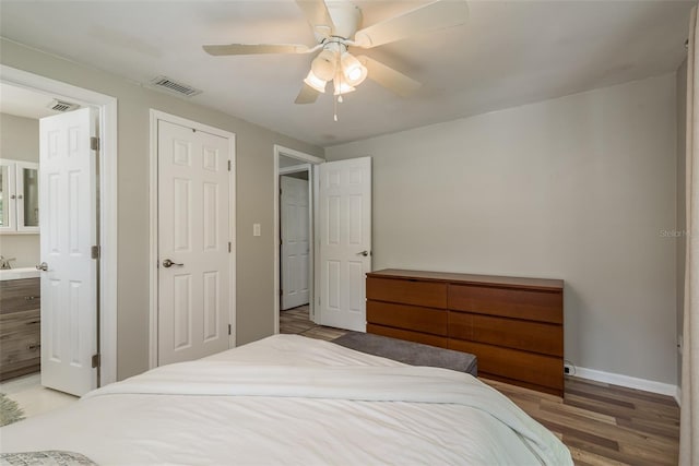bedroom featuring visible vents, baseboards, light wood finished floors, and ceiling fan