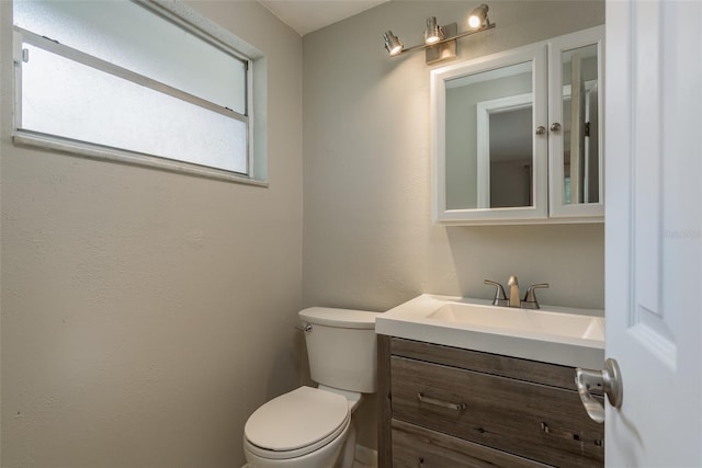 half bathroom with toilet and vanity