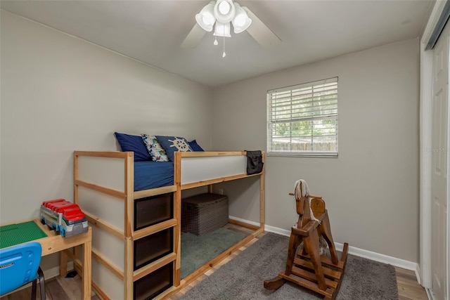 bedroom featuring wood finished floors, ceiling fan, and baseboards