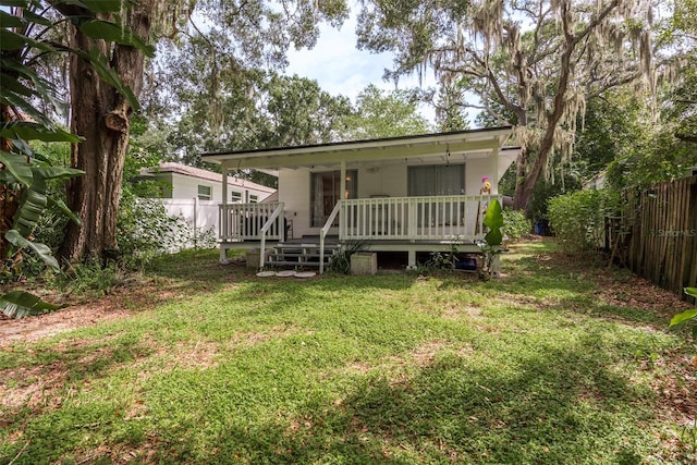 back of house with a yard and a fenced backyard