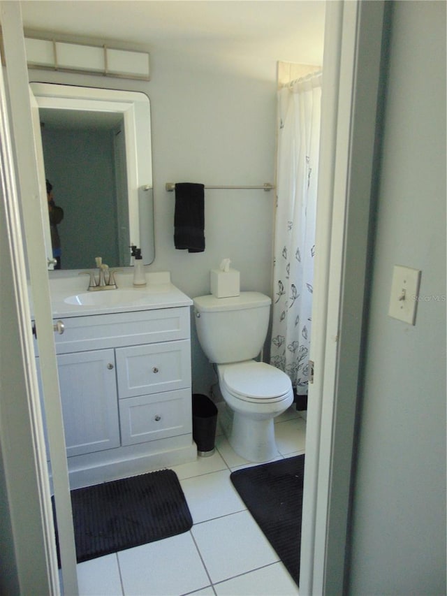 bathroom with toilet, tile patterned flooring, a shower with shower curtain, and vanity