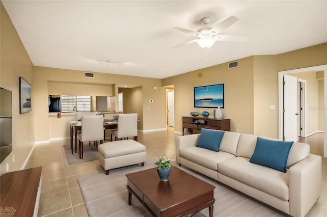 living room with ceiling fan and light tile patterned flooring