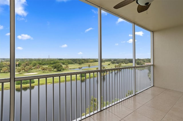 unfurnished sunroom with a water view and ceiling fan