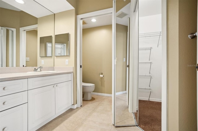 bathroom featuring tile patterned floors, toilet, and vanity