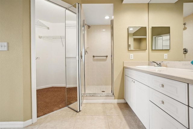 bathroom featuring vanity, tile patterned floors, and a shower with door