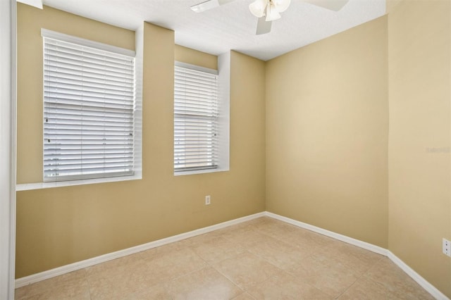 spare room with a textured ceiling and ceiling fan