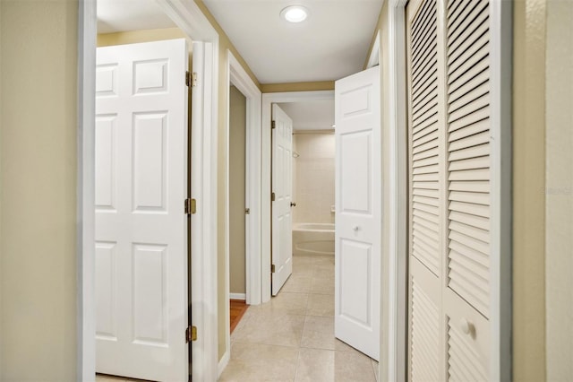 hall featuring light tile patterned flooring