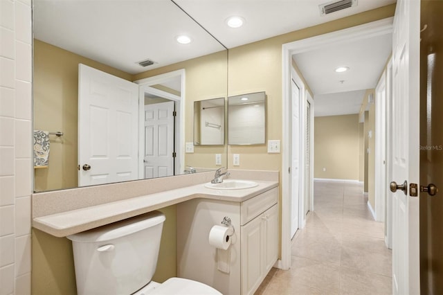 bathroom with tile patterned flooring, vanity, and toilet