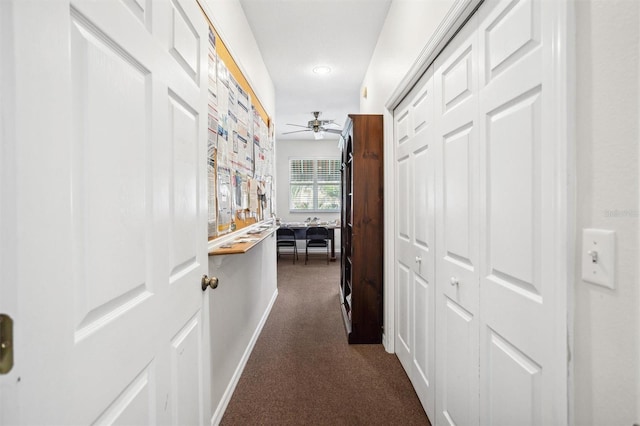 hallway featuring dark carpet