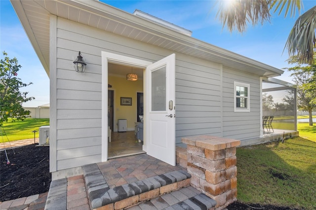 doorway to property featuring a yard