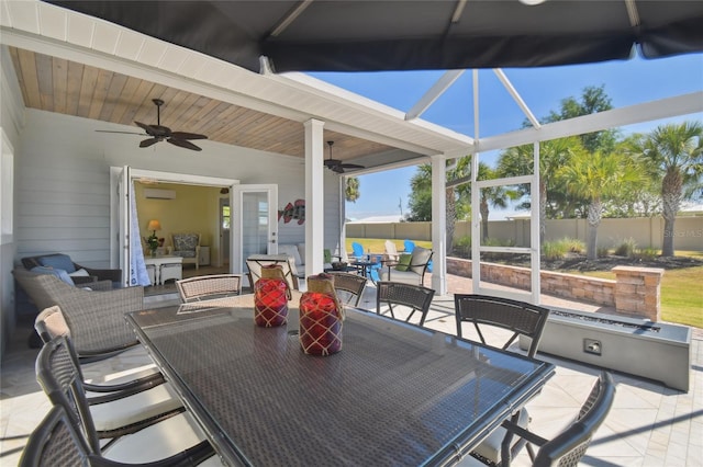 view of patio / terrace with an outdoor living space, a wall mounted AC, and ceiling fan